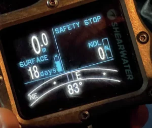 The digital display of an electronic scuba compass showing degrees and navigation heading