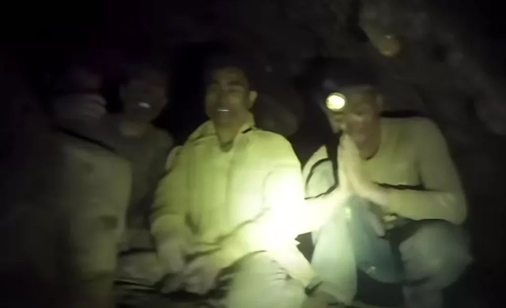 The villagers greet the two cave-divers 