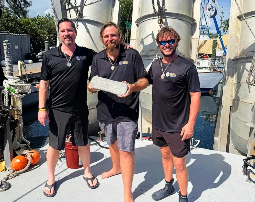 Drake Nicholas with the Atocha ingot - Blake Baxter on the right is lead diver (Mel Fisher's Shipwreck Expeditions)