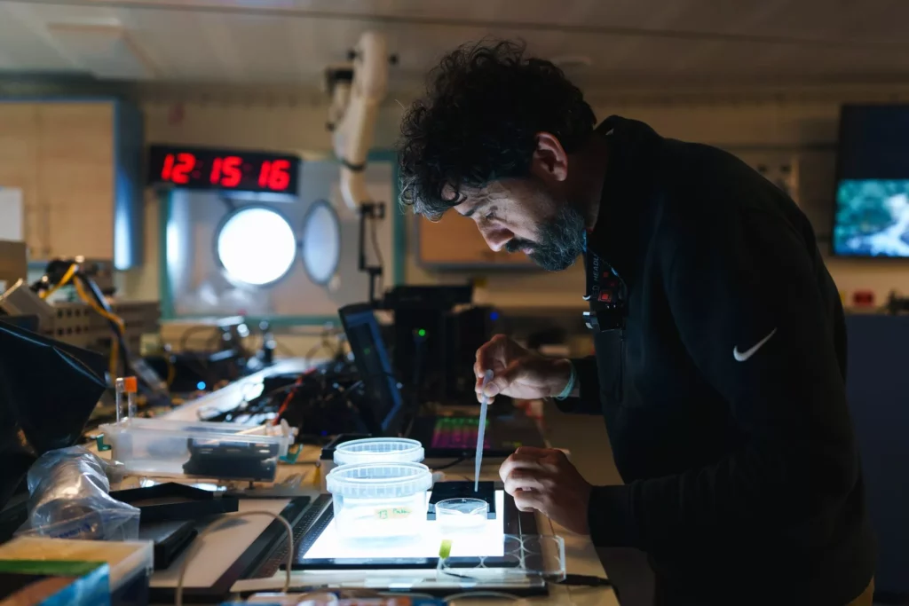 Dr Manu Prakash at work in the main laboratory on Falkor (too) (ALex Ingle / Schmidt Ocean Institute)