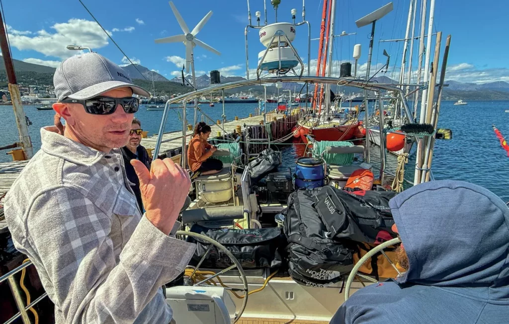 Crew members loading equipment onto an expedition yacht in Ushuaia, Argentina.
