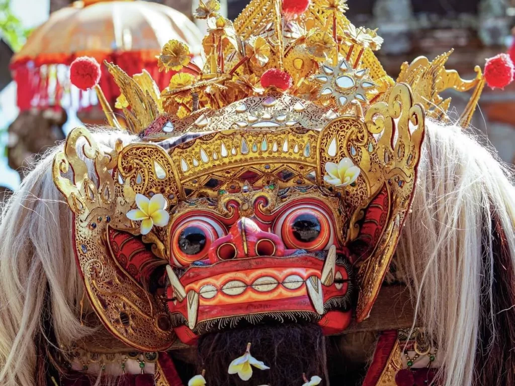 Performers wearing vibrant, elaborate traditional Balinese costumes during a cultural temple performance in Bali.