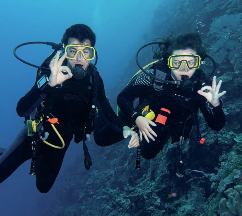 Newly certified divers Aura and Ian Chatham exploring an aquatic wonderland with a sea breeze in the air, coral in my heart.