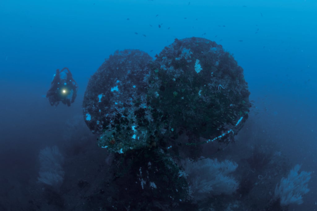 A rebreather diver investigates one of the propellers