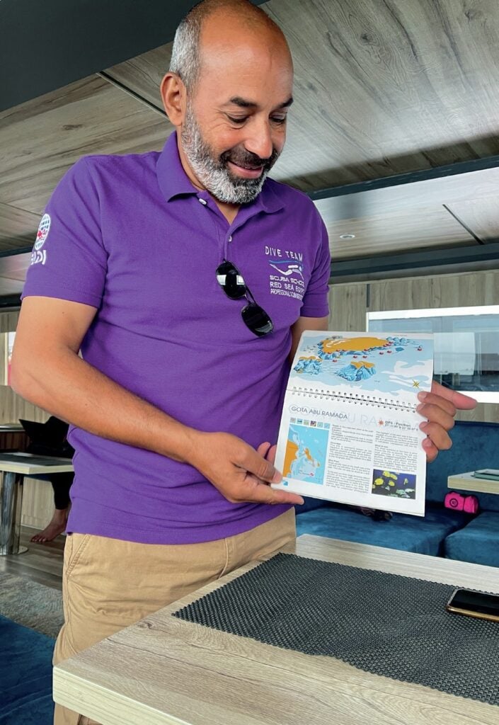 Dive instructor Osama giving briefing before Red Sea boat dive