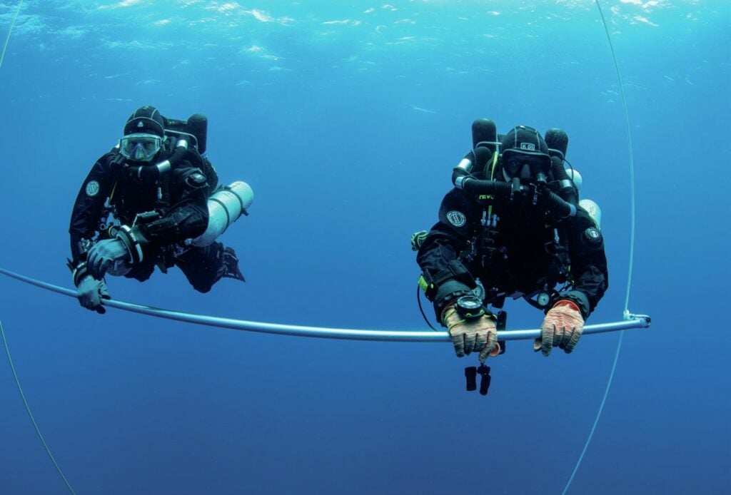 Technical divers completing decompression stops at a deco station above the HMS Southwold wreck