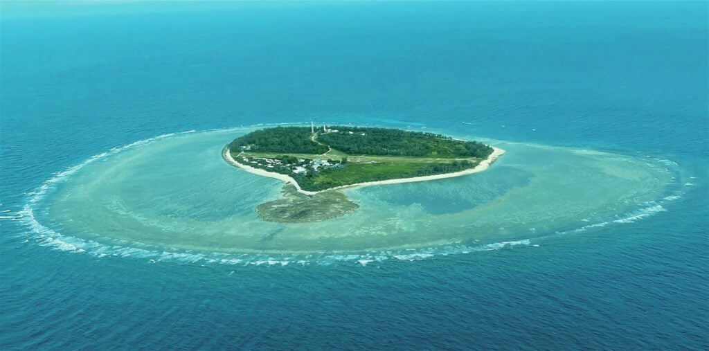 Aerial drone view of Lady Elliot Island and surrounding Great Barrier Reef, showing coral reefs and turquoise waters